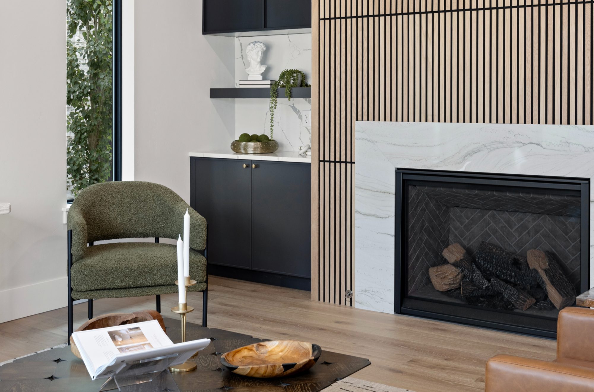 Living room with deep green built-ins framing the fireplace