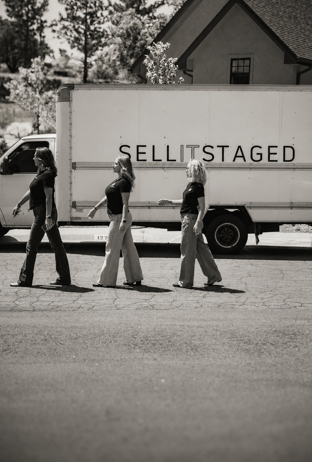 The SELLITSTAGED team walking past the branded staging truck